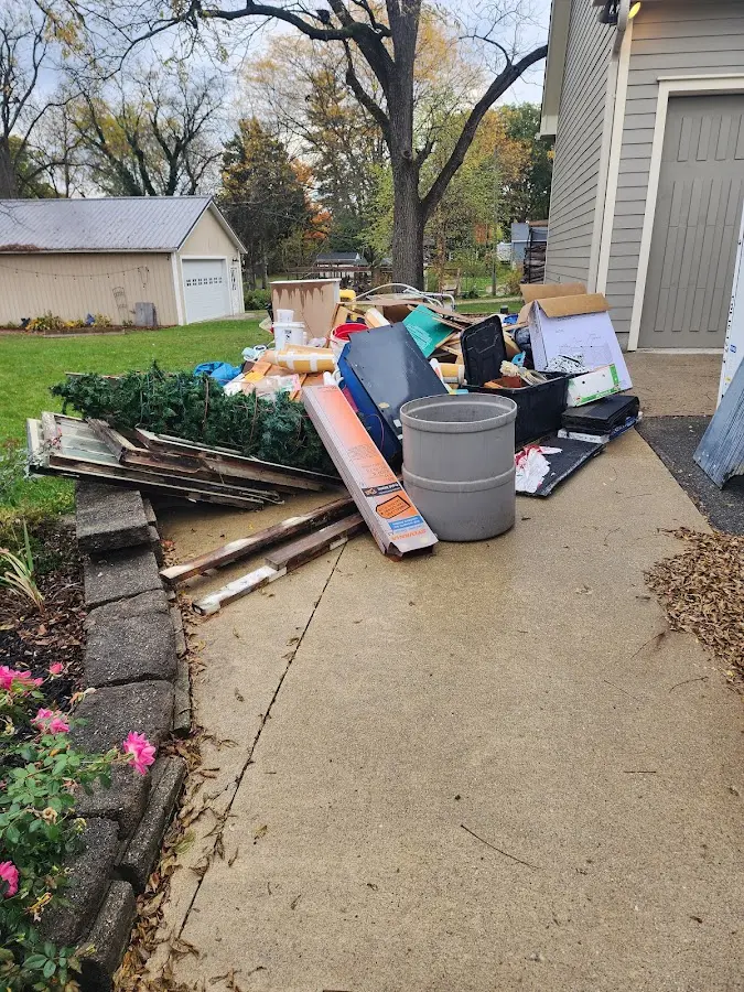 Dumpster being loaded with debris for Roofing Dumpster Rental in Benton